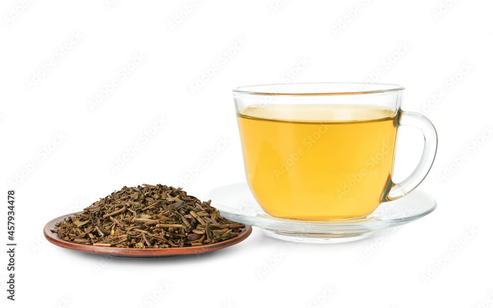 Saucer with dry hojicha green tea and cup of hot beverage on white background Saucer with dry hojicha green tea and cup of hot beverage on white background
