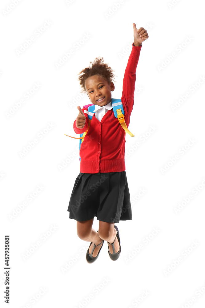Jumping African-American schoolgirl showing thumbs-up on white background Jumping African-American schoolgirl showing thumbs-up on white background