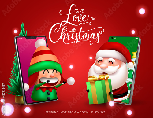 Christmas gift giving characters vector design. Give love on christmas day text with virtual santa claus and cute elf character in mobile phone holding gift for xmas holiday season. 