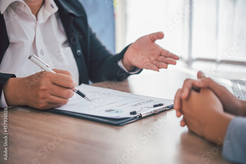 Human resource manager Is explaining the job to the job seeker before filling out a resume on the application form to consider accepting for employment in the company..