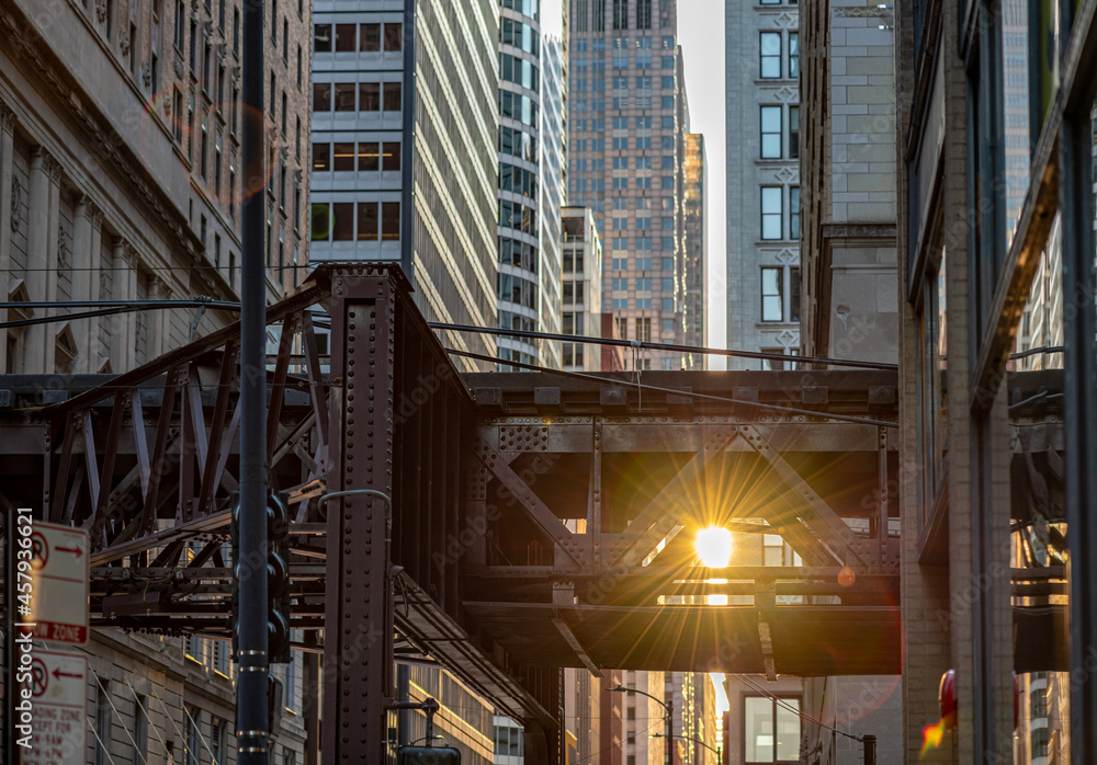 In Chicago, the sun shines brightly through space in the train tracks of the famous L or Elevated Train, downtown in the Loop.