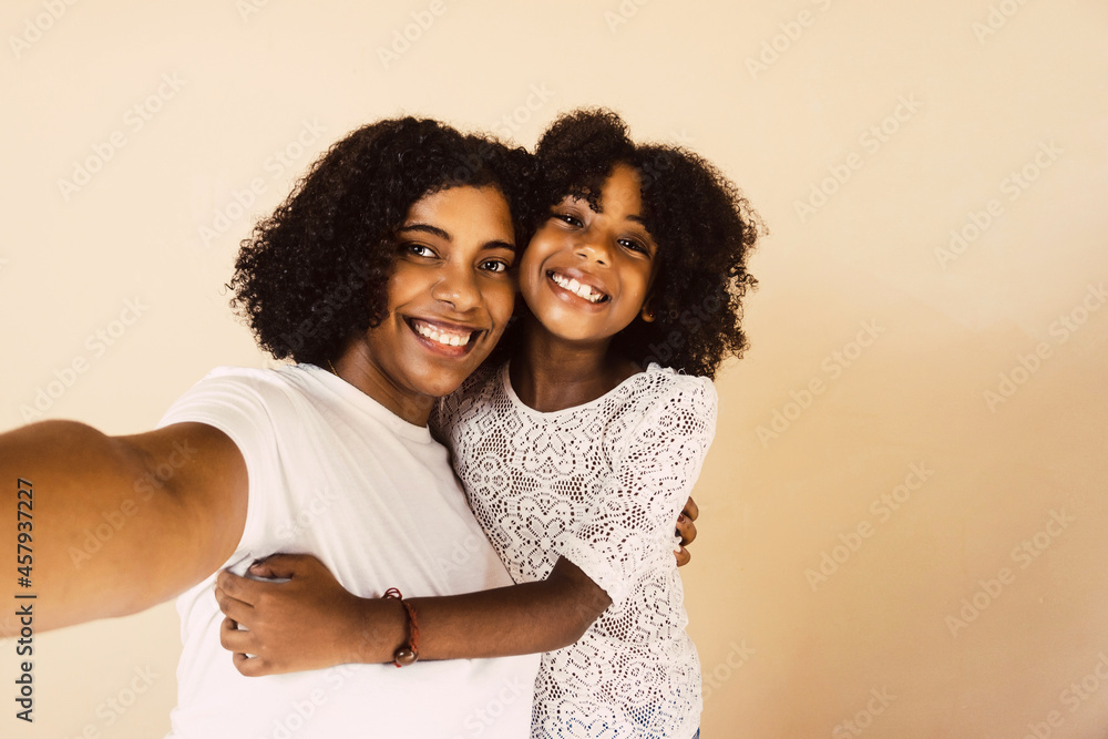 portrait of mother and daughter taking a selfie. portrait of mother and daughter taking a selfie.