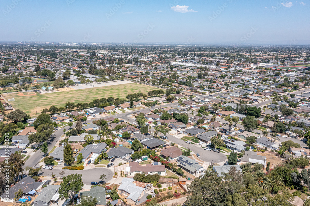 Aerial view of a Los Angeles suburban neighborhood on a hot day, large sports park, high school and field