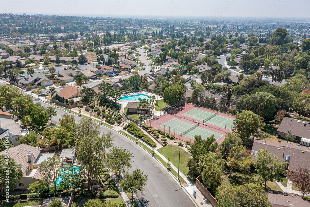 Birds Eye View of a Community Center With Tennis Courts and a Swimming Pool