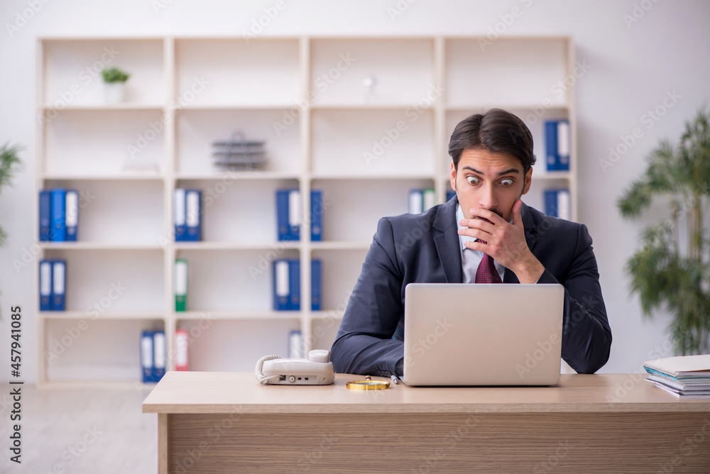 Young male employee working in the office Young male employee working in the office