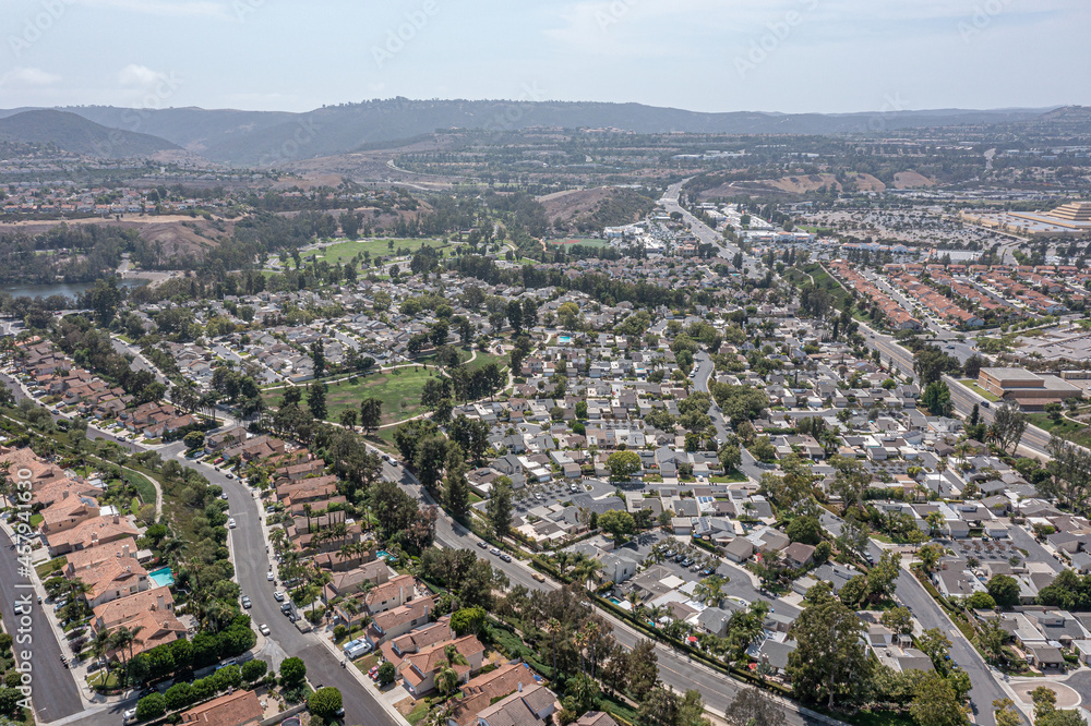 Aerial view of a southern California coastal community on a hill with a highway running through.
