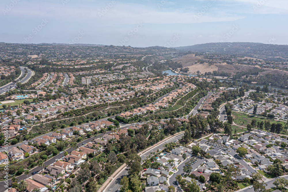 Aerial view of a southern California coastal community on a hill with a community lake in the background