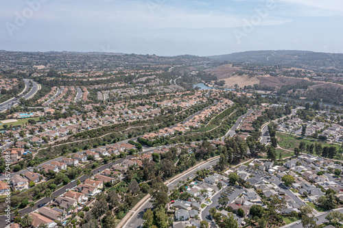 Aerial view of a southern California coastal community on a hill with a community lake in the background photo