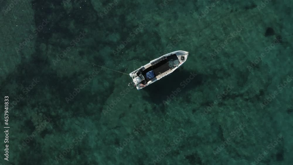 Speed boat lost on the waters of Milos island Greece, aerial reveal shot Speed boat lost on the waters of Milos island Greece, aerial reveal shot