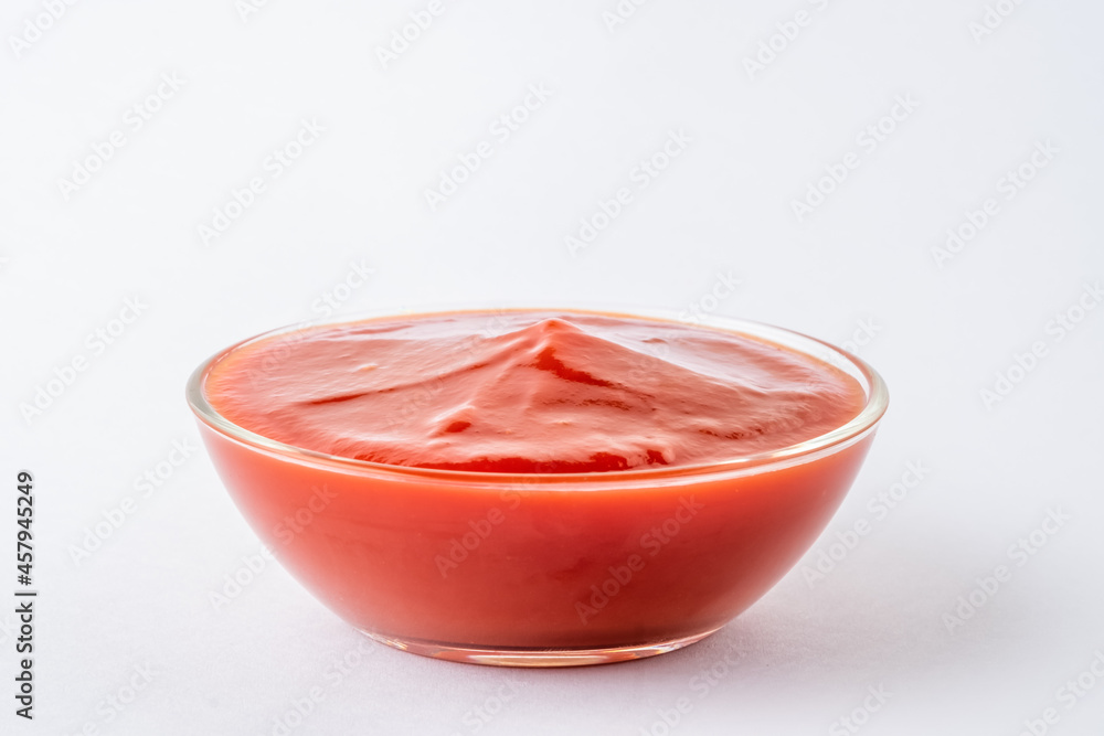 Tomato ketchup in glass bowl on white background. Tomato ketchup in glass bowl on white background.