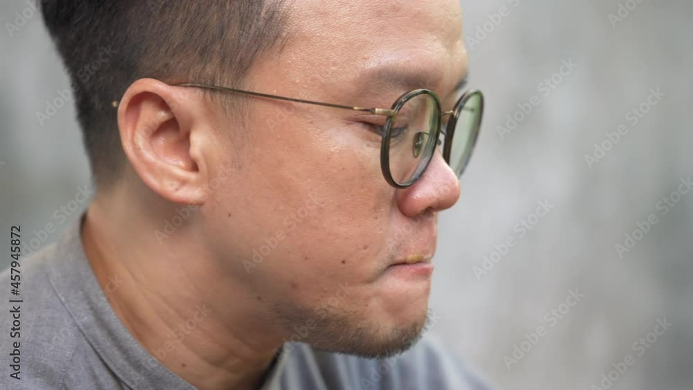 4K Close up of Asian man relax and enjoy drinking coffee latte in coffee shop. Confidence male holding coffee cup and enjoy drinking tasty and scented coffee. Small business restaurant owner concept. 4K Close up of Asian man relax and enjoy drinking coffee latte in coffee shop. Confidence male holding coffee cup and enjoy drinking tasty and scented coffee. Small business restaurant owner concept.