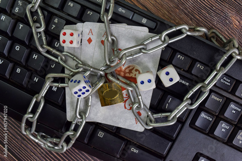 Padlock and playing cards. Isolated on laptop keyboard. Onlie gambling concept.