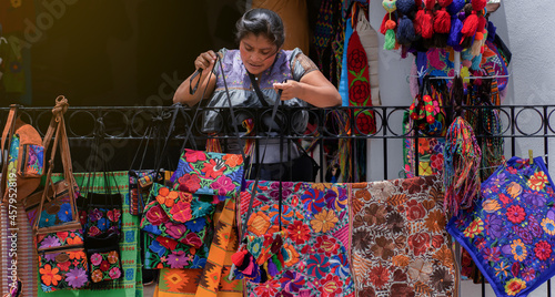 woman selling traditional Mexican handicrafts from Chiapas, woman offering her products for sale