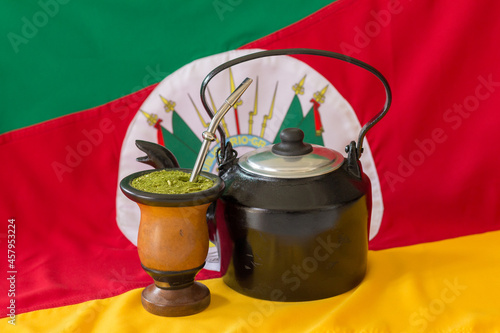 Kettle, mate and state flag of Rio Grande do Sul - Brazil in the background. Decoration in celebration of the traditional week of the south of Brazil. 