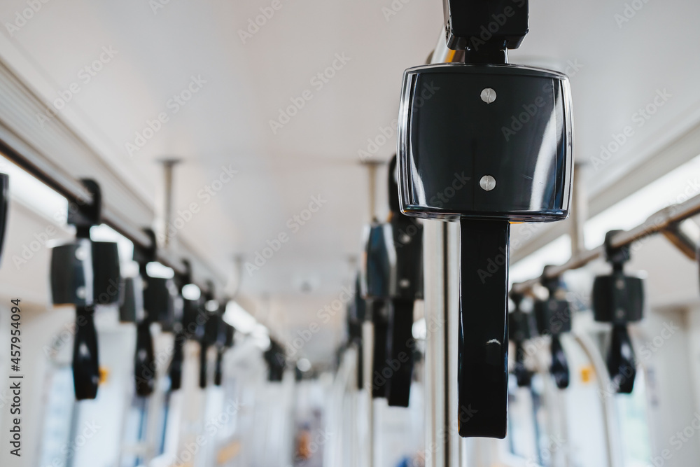 Selective focus on holding hand grip on the subway train Selective focus on holding hand grip on the subway train