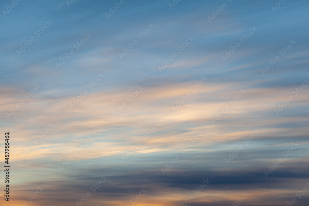 Colorful sunset or sunrise in the sky. The sky and clouds are painted in different delicate colors.