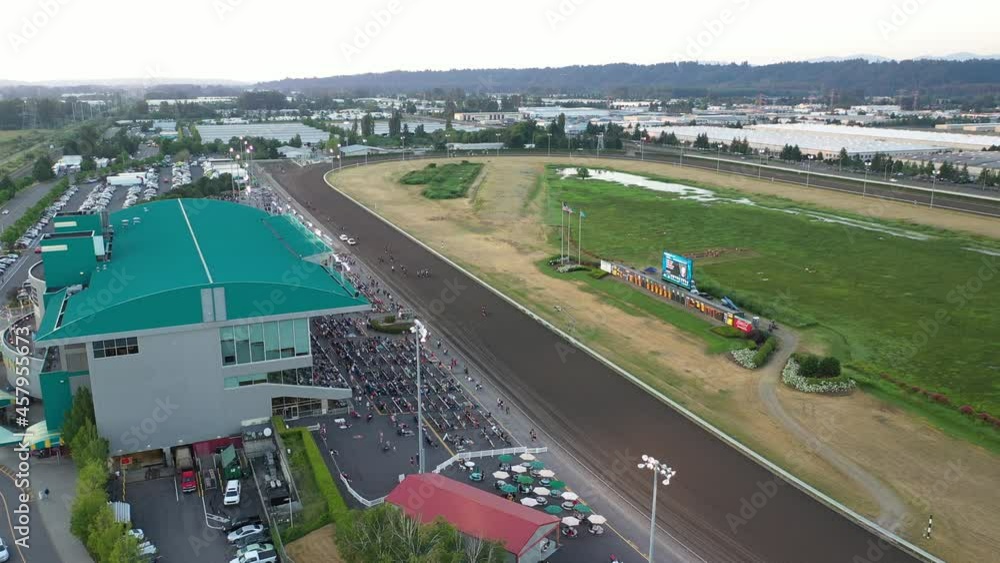 Cinematic 4K aerial drone cli[ of a horse race at Emerald Downs, a thoroughbred racetrack with a green grandstand in Auburn, Washington, near Highway 167 Cinematic 4K aerial drone cli[ of a horse race at Emerald Downs, a thoroughbred racetrack with a green grandstand in Auburn, Washington, near Highway 167