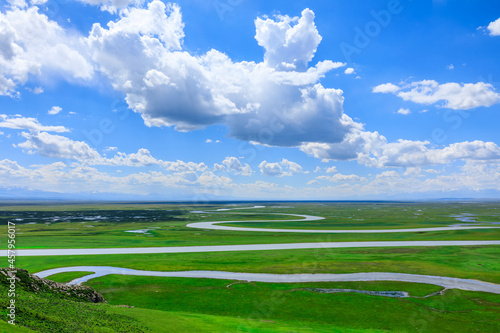 Bayinbuluke grassland natural scenery in Xinjiang,China.The winding river is on the green grassland.Famous tourist attractions. photo