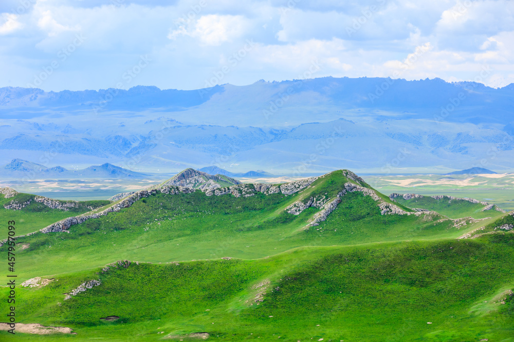 Green grassland and mountain natural landscape in Xinjiang,China.Beautiful prairie scenery.