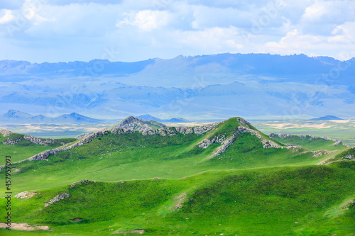 Green grassland and mountain natural landscape in Xinjiang,China.Beautiful prairie scenery.