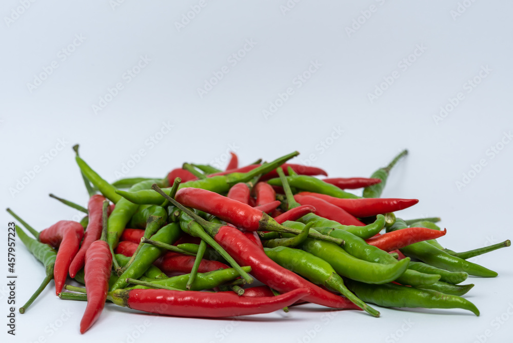 Red and green hot chili peppers isolated on white background. Red and green hot chili peppers isolated on white background.