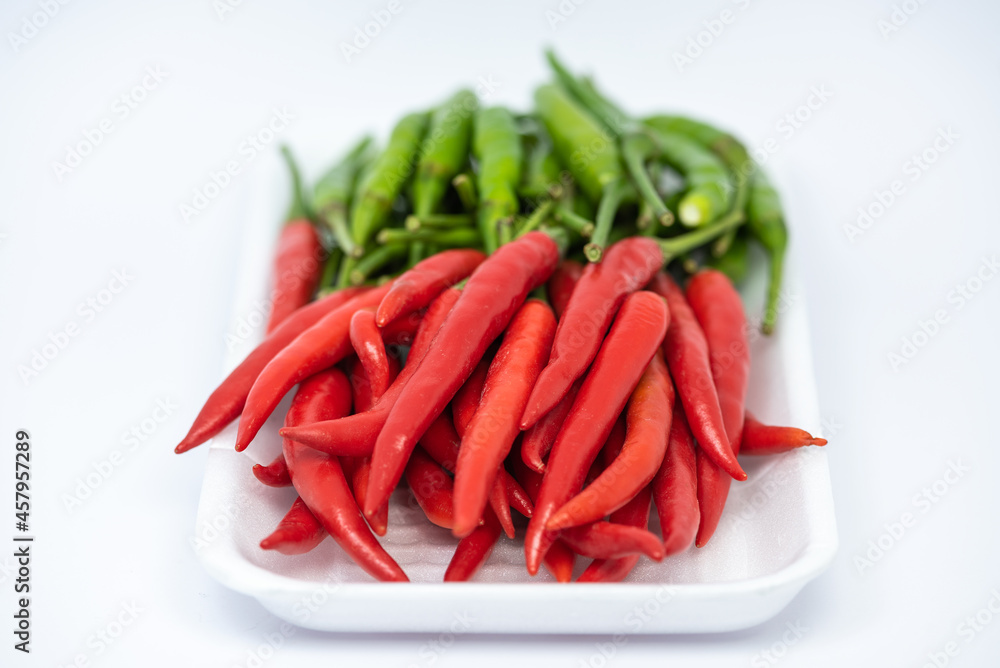 Red and green hot chili peppers isolated on white background. Red and green hot chili peppers isolated on white background.