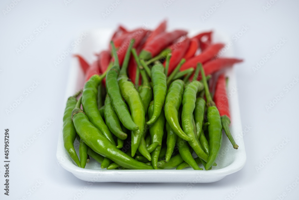 Red and green hot chili peppers isolated on white background. Red and green hot chili peppers isolated on white background.