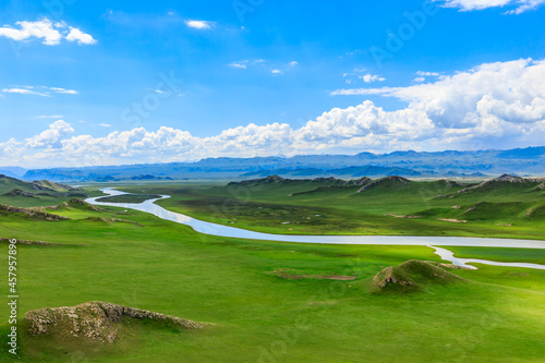 Bayinbuluke grassland natural scenery in Xinjiang,China.The winding river is on the green grassland. photo