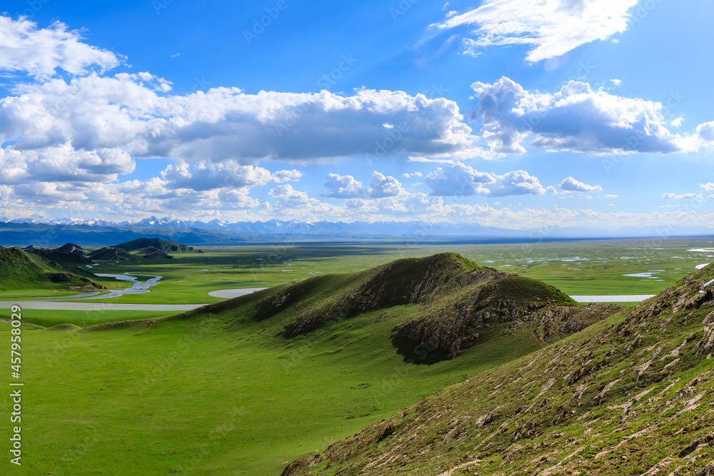 Bayinbuluke grassland natural scenery in Xinjiang,China.The winding river is on the green grassland. Bayinbuluke grassland natural scenery in Xinjiang,China.The winding river is on the green grassland.