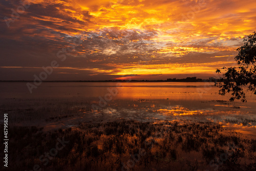 Scenic view dramatic beautiful sunset sky. Natural Sunset Sunrise on meadow silhouette shadow dark land. Vibrant dramatic sky on sunset  dawn  sunrise in Countryside. Landscape Colorful Sky At Sunset