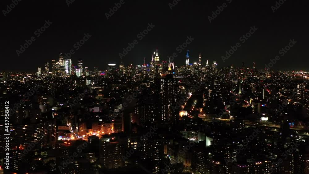 Drone Night Shot Of The New York City Manhattan Skyline, Empire State Building and housing projects at night Drone Night Shot Of The New York City Manhattan Skyline, Empire State Building and housing projects at night