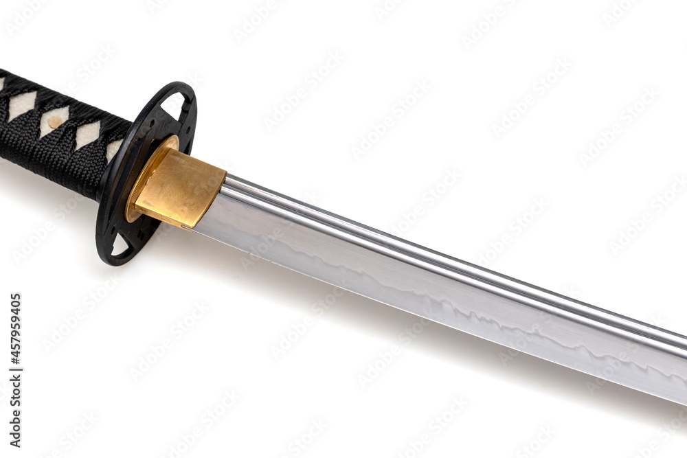 Japanese sword blade (made in China) on white background. Soft focus. The wavy pattern on the blade edge is a line of hardness that a blacksmith makes so that the blade doesn't break. Japanese sword blade (made in China) on white background. Soft focus. The wavy pattern on the blade edge is a line of hardness that a blacksmith makes so that the blade doesn't break.