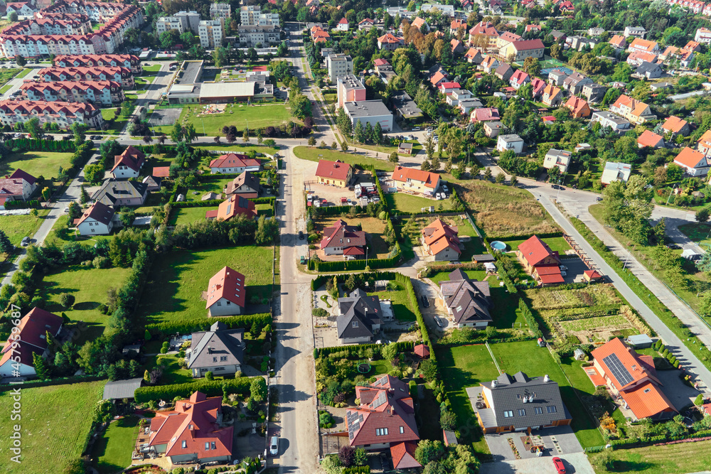 Modern residential district in Europe town, aerial view. Residential neigborhood, bird eye view. City streets with luxury house buildings and parked car