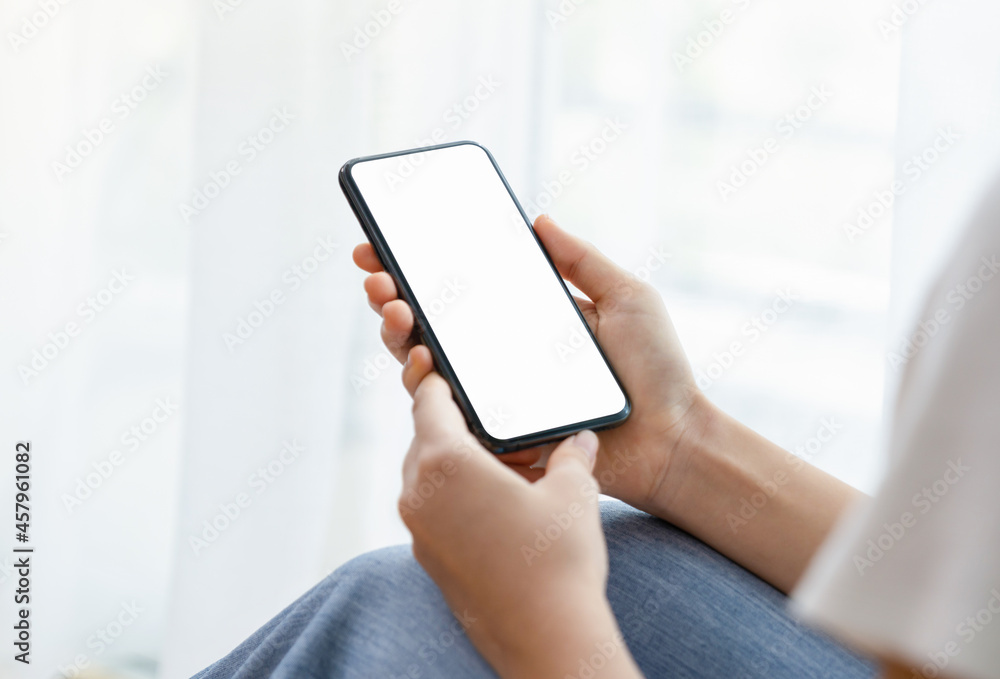 Close up of hand holding smartphone with white mock-up screen. Close up of hand holding smartphone with white mock-up screen.