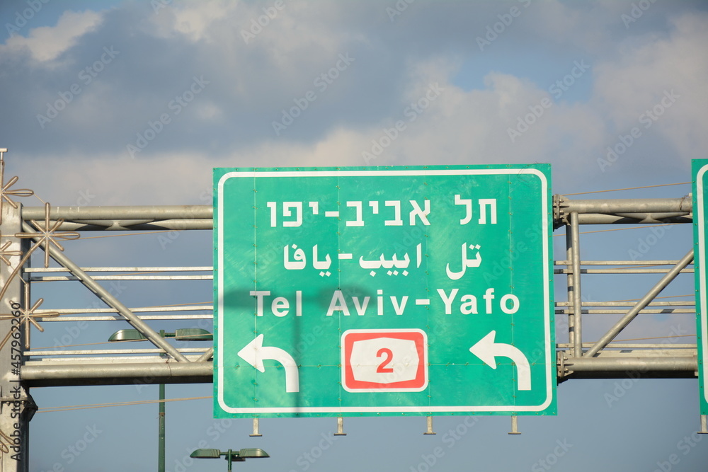 Obraz premium Traffic (Road) sign to Tel Aviv. Tel Aviv to Haifa, Highway 2 in Israel. Trilingual road sign in Israel