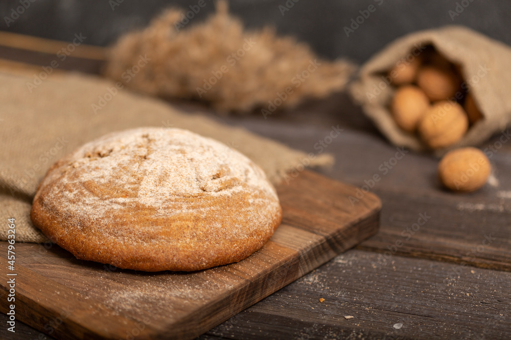 Fresh crispy baguette on a wooden board. Sliced traditional french bread. Close-up Fresh crispy baguette on a wooden board. Sliced traditional french bread. Close-up