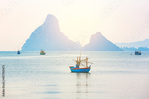 Beautiful seascape view fishing boats and soft warm sunlight at Hua Hin beach, Prachuap Khiri Khan Province, Thailand.