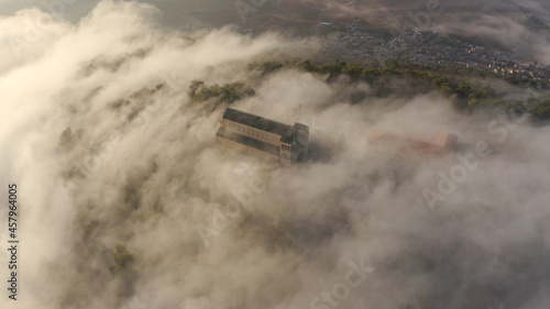Aerial view over Mount Tavor and Church of the Transfiguration
Drone view from North Israel at sunrise covered with clouds, 2021
