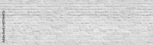 White old shabby brick wall wide panoramic texture. Light gray rough whitewashed brickwork panorama. Abstract rustic vintage background © JAYANNPO