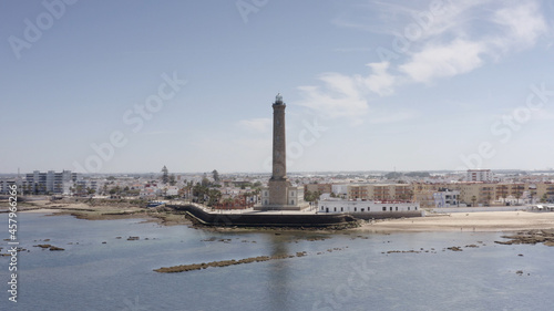 Aerial view over large Lighthouse in Chipiona, spain
Drone view from Chipiona spain, 2021
 photo