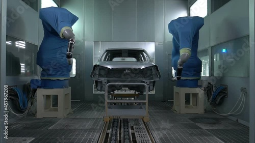 Industrial spray painting process. Auto robot painter sprays white paint on the car body in special booth. Painting vehicle parts at car factory.