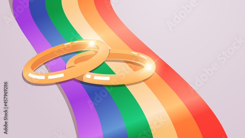 wedding golden rings on rainbow flag transgender love LGBT community tolerance freedom concept
