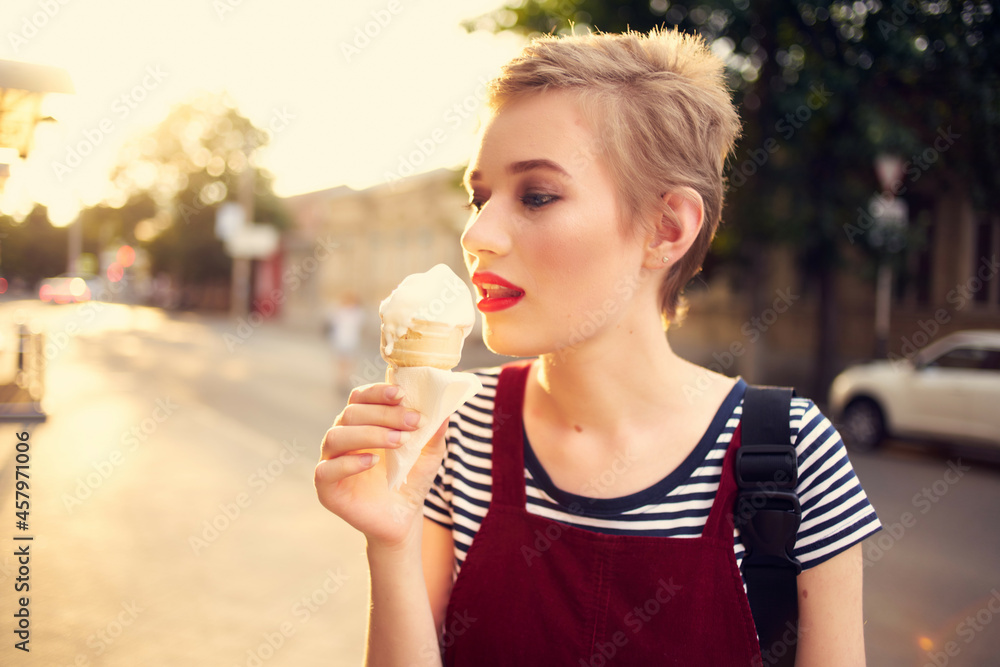 short haired woman eating ice cream outdoors in summer short haired woman eating ice cream outdoors in summer