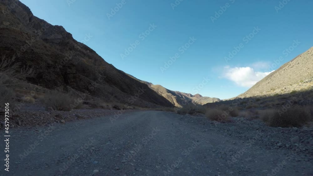 Shadowy Gravel Road Heads Toward Titus Canyon in Death Valley National Park Shadowy Gravel Road Heads Toward Titus Canyon in Death Valley National Park