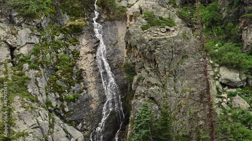 Snow Melt Cascades Down Steep Rocky Cliff in Rocky Mountains National Park Snow Melt Cascades Down Steep Rocky Cliff in Rocky Mountains National Park