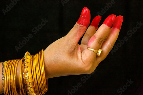 Woman dancer hand showing Kangula hasta depicting bell or fruits in Indian classical dance Bharata Natyam photo