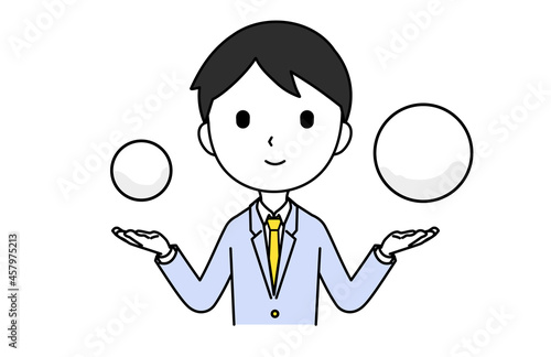 両手にモノを持って比べる男性