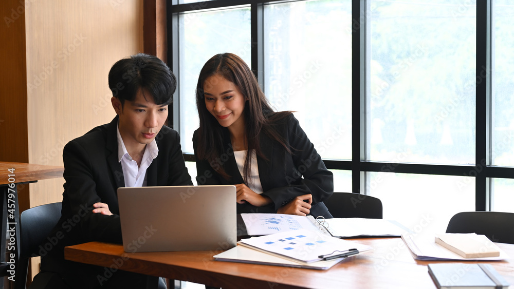 Business people discussing business data together on computer laptop. Business people discussing business data together on computer laptop.