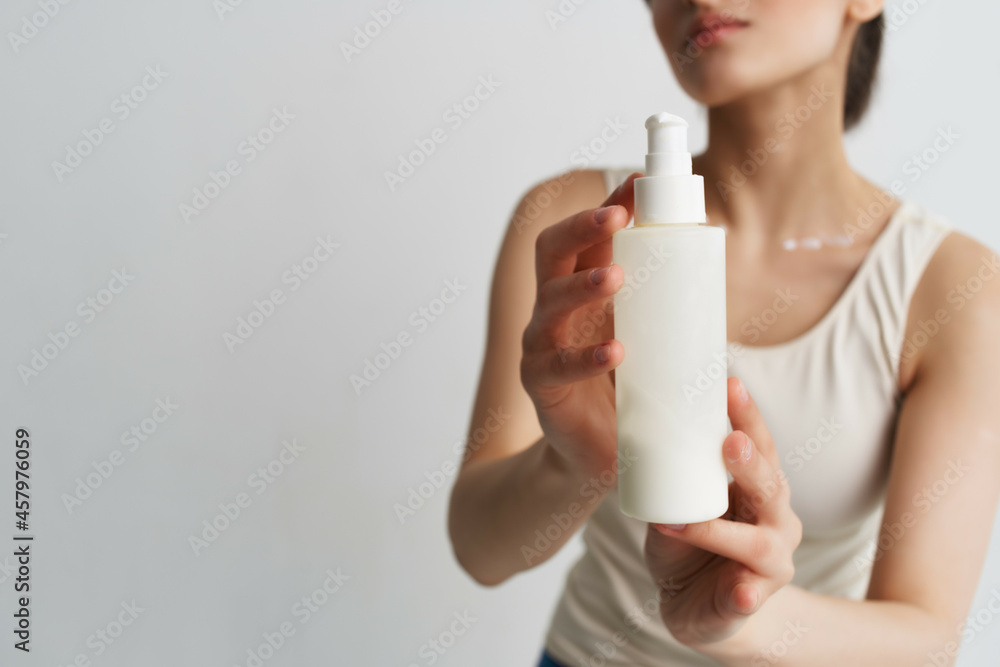 woman in white t-shirt apply lotion on hand moisturizing clean skin woman in white t-shirt apply lotion on hand moisturizing clean skin