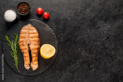 grilled salmon steak on stone background with copy space for your text